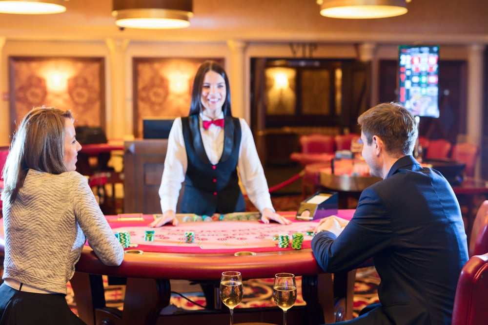 casino dealer at poker table